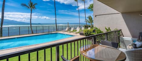 Covered patio overlooking the pool and ocean