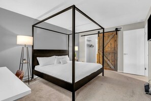 The master bedroom has all the comforts needed for a restful stay with a king-size bed, blackout curtains, a workspace, a walk-in closet and private bathroom.