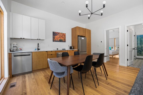 Dining room and kitchen with door to bedroom and bathroom