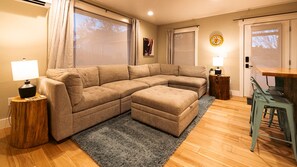 Living room - sectional can be rearranged to create a comfortable queen-size bed.