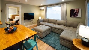 Living room with 55" HDTV and mini-split for heating and air conditioning.