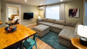 Living room with 55" HDTV and mini-split for heating and air conditioning.