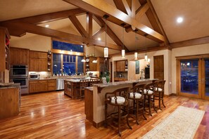Expansive kitchen with eat-at island and bar area