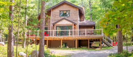 This beautiful vacation home has an expansive deck with plenty of seating for your friends and family.