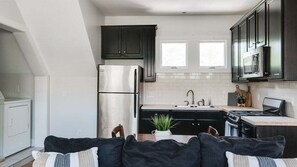 Stylish cabinetry and stainless appliances in a compact layout.