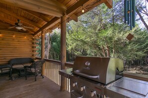 Covered deck with gas grill.