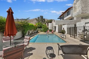 Semi-private pool is steps away. Condo above w/ blue umbrella, spiral staircase