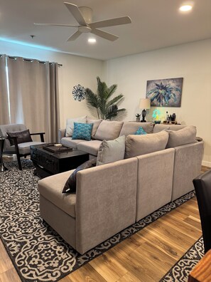 Living area. Sectional modular sofa with 6-7 seats- L shaped.  Club chair.