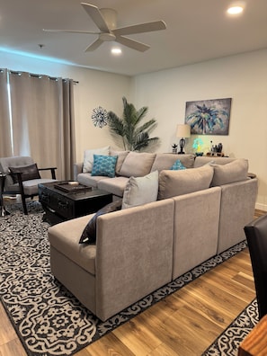 Living area. Sectional modular sofa with 6-7 seats- L shaped. Club chair.
