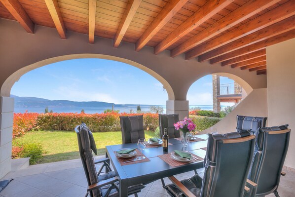 Terrace with table and chairs, private garden and lake view