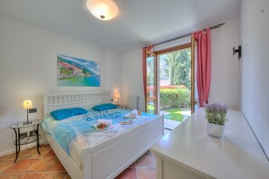 Double room with besides table and wardrobe and terrace access