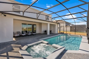 Large swimming pool with spa and covered outdoor dining area