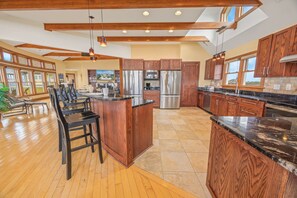 There can never be too many cooks in this kitchen which features granite countertops, 2 refrigerators, 2 dishwashers, and an ice maker.