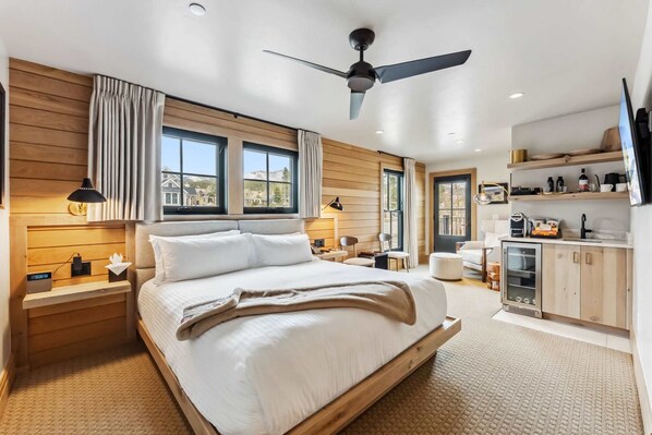 Suite Interior: King bed, 55” Smart TV, Bluetooth speaker, humidifier, dining nook, kitchenette