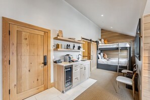 Suite Interior: King bed, twin bunk-beds, kitchenette, bay window, wardrobes