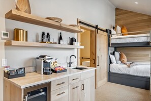 Suite Interior: King bed, twin bunk-beds, kitchenette, bay window, wardrobes