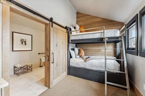 Suite Interior: King bed, twin bunk-beds, kitchenette, bay window, wardrobes