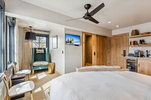 Suite Interior: King bed, 40" Smart TV, Bluetooth speaker, humidifier, Topo Designs backpack, yoga mat, reading chair