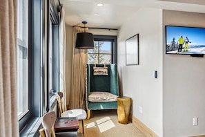 Suite Interior: King bed, 40" Smart TV, Bluetooth speaker, humidifier, Topo Designs backpack, yoga mat, reading chair