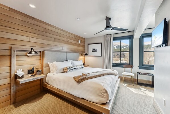 Suite Interior: King bed, 40" Smart TV, Bluetooth speaker, humidifier, Topo Designs backpack, yoga mat, reading chair