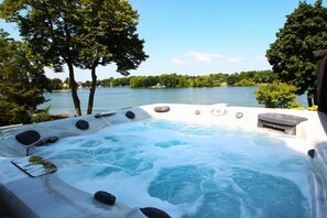 Enjoy the evening in the hot tub overlooking the water.
