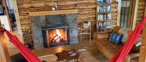 Living room, complete with large fireplace and hammock