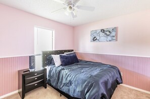 Bedroom with queen size bed and smart Tv.