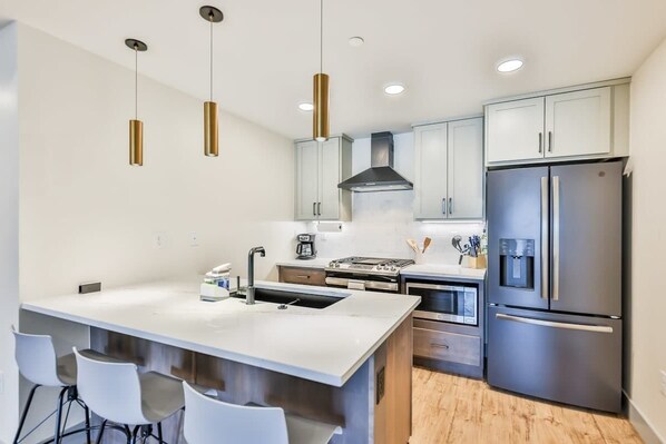 Gather in the beautifully designed kitchen and dining area, where modern appliances and stylish finishes create the perfect space for cooking and entertaining. The dining area offers a comfortable spot for family meals and casual dining, making it id