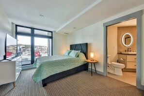 Luxurious private master bedroom featuring a spacious walk-in closet and a large window that fills the room with natural light. This elegant space offers ample storage and a serene atmosphere, perfect for relaxation and personal retreat. Ideal for th