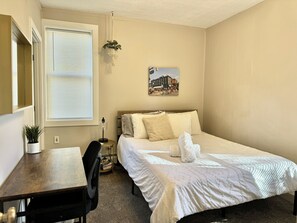 The bedroom has a window AC for warmer days.