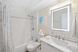 Bright and stylish bathroom featuring a tiled shower, and minimalist design
