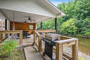 Outdoor pavilion has a BBQ Grill, picnic tables, swings, a seating area, and outdoor lights/fans.