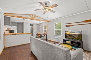 Living area of the cottage includes a Smart TV, board games and a comfortable sofa.