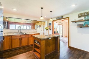 Open kitchen area overlooks the dining and picture window, opens to living room