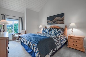 Master bedroom with king bed, mountain/stream views, and sitting area.