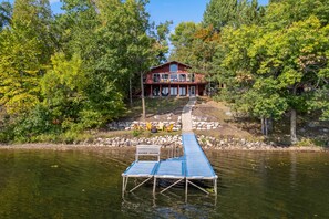 Gradual stairs lead to the lakeside firepit, dock, and swimming area