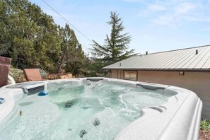 The hot tub has seating for several friends and family members