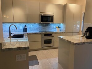 Modern kitchen - Bosch induction stovetop, Dacor oven, and Jenn-Air microwave. 