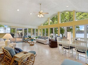 `From inside the sunroom, the wall of windows captures amazing lake views