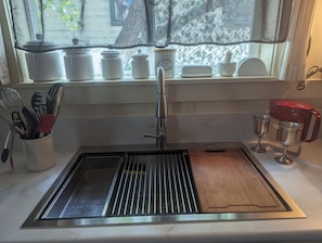 Farm style sink,  colander, roll up drain rack, chopping board., space saver.