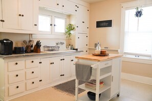 Bright & spacious kitchen with a view of dining room into living room