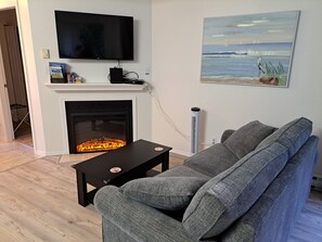 Living room with sofa, TV and fireplace