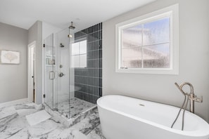 Glass rainfall shower or sit back and relax in the soaking tub