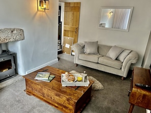 Living room with beautiful log burner. 
