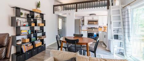 Open concept living room, dining area, and kitchen.  The natural light pours in from the side patio door.