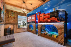 Magical Harry Potter-themed room with train bunk beds and enchanting decor.