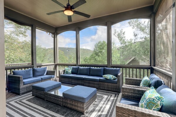 Screened-In Porch with a Cozy Seating Area to Enjoy the Beautiful Views
