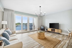 Living Area with Lake and Light Show Views, Flat Screen TV, Sleeper Sofa and Private Balcony Access