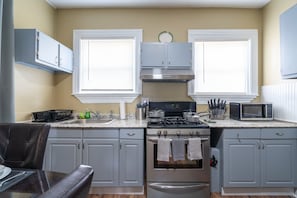 Kitchen: Brita water filter, cleaning supplies, + fire extinguisher under sink.