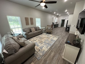 Living area with pull out couch and area for air mattress for kids. 